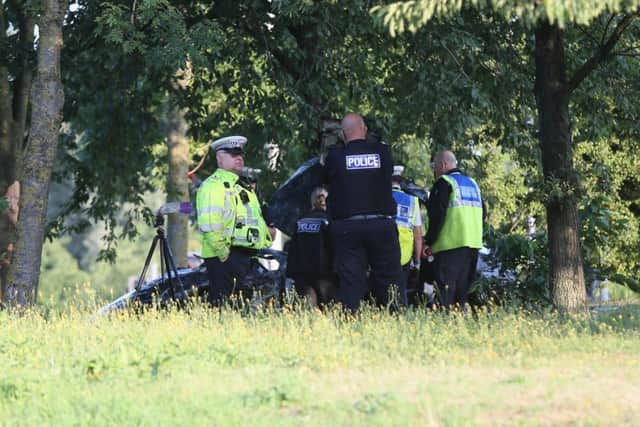 Police at the scene of the Frank Perkins Parkway crash. Photo: Terry Harris