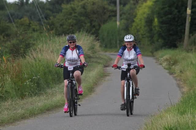 Jacqui Parker (white helmet) and Kay Starbuck-Chapman (black helmet) cycled 60 miles to raise money as tribute to Jacquis sister-in-law