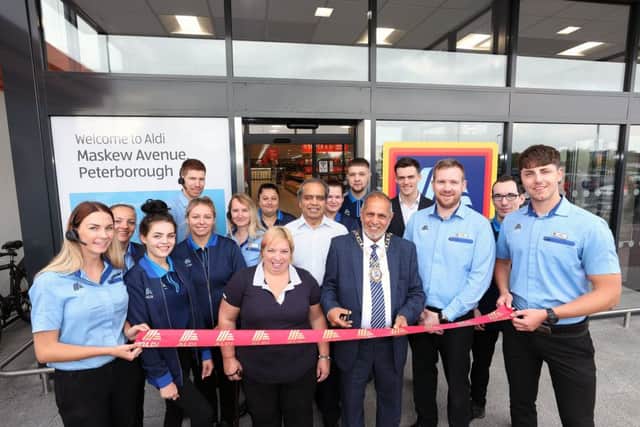 Mayor of Peterborough Cllr Gul Nawaz opens the new store with manager Rob Place and staff