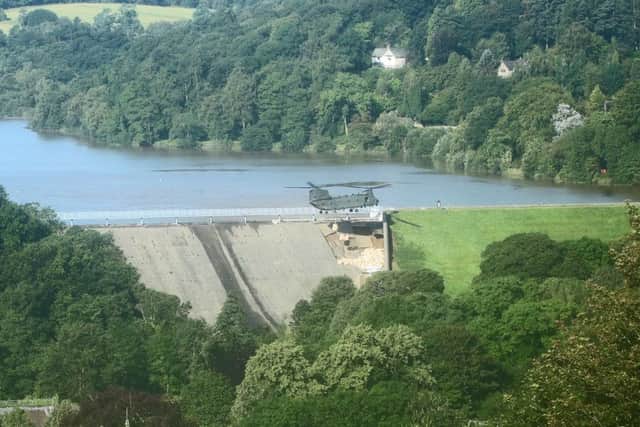 An RAF Chinook helicopter flies in sandbags to help repair the dam at Toddbrook reservoir near the village of Whaley Bridge in Derbyshire after it was damaged by heavy rainfall. Photo: Danny Lawson/PA Wire