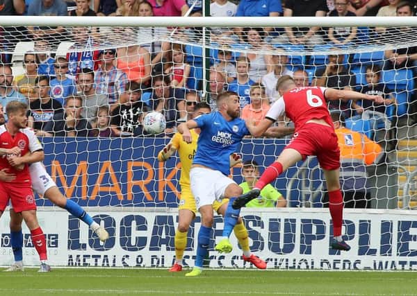 New Posh centre-back Mark Beevers is beaten to the ball by Fleetwood's Harry Souttar. Photo: Joe Dent/theposh.com.