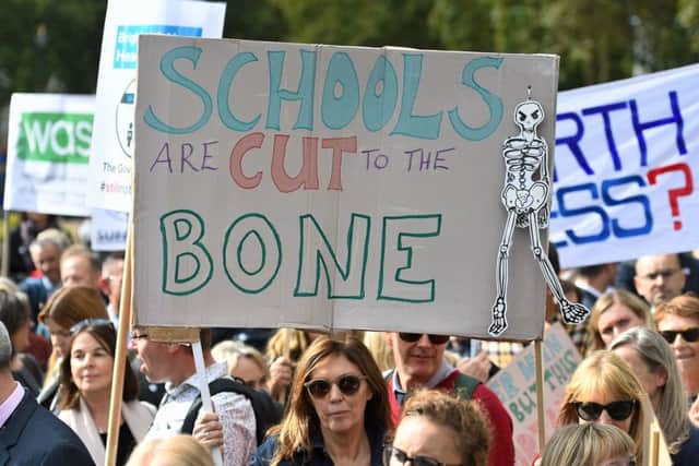 Headteachers from across England and Wales hold signs in Parliament Square, London, as they prepare to march on Downing Street to demand extra cash for schools. PRESS ASSOCIATION Photo. Picture date: Friday September 28, 2018. See PA story EDUCATION Headteachers. Photo credit should read: Kirsty O'Connor/PA Wire EMN-180928-141455001