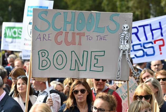 Headteachers from across England and Wales hold signs in Parliament Square, London, as they prepare to march on Downing Street to demand extra cash for schools. PRESS ASSOCIATION Photo. Picture date: Friday September 28, 2018. See PA story EDUCATION Headteachers. Photo credit should read: Kirsty O'Connor/PA Wire EMN-180928-141455001