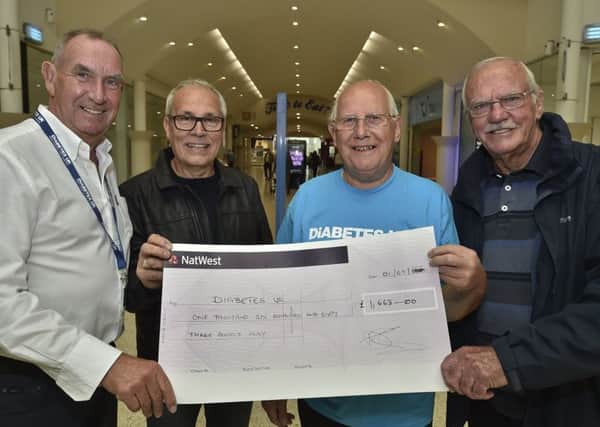 David Robinson from Diabetics UK receives a cheque from  fundraisers Roger Spires, Richard Salmon and Bill Wright from The Intruders band. EMN-190909-153350009