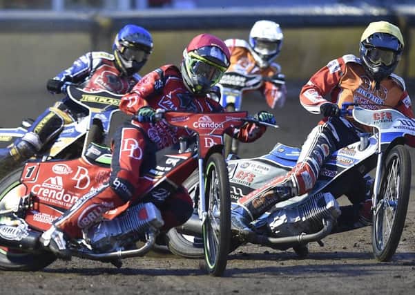 Charles Wright (red helmet) in heat one action from Panthers v Swindon. Photo: David Lowndes.
