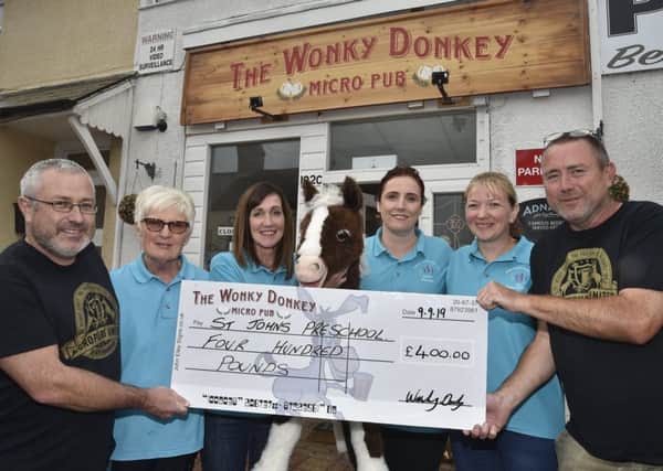 Cheque presentation at the Wonky Donkey, Fletton High Street to members of the St John's pre-school in Stanground