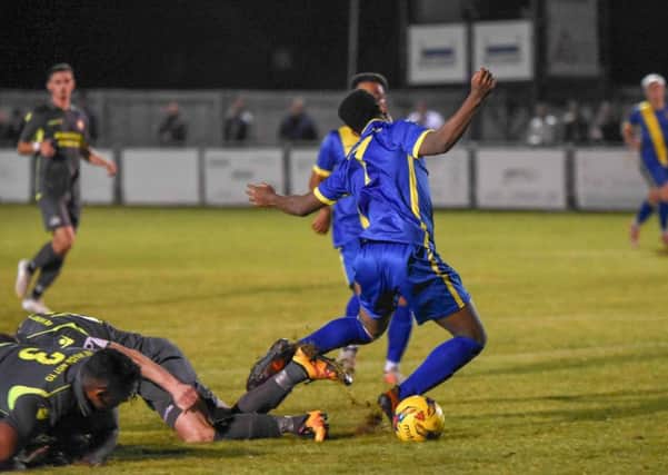 Peterborough Sports' Dion Sembie-Ferris goes down under a challenge in the FA Cup win over East Thurrock. Photo: James Richardson.