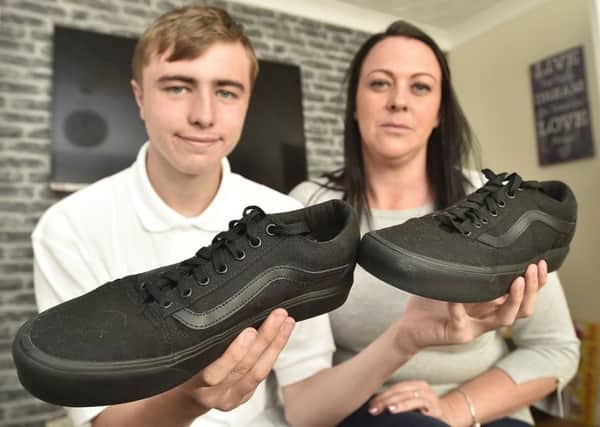 Nicki Mawby and her son Tyler Hickin with his shoes which the school will not allow. EMN-191109-081411009