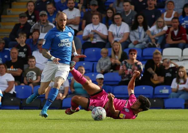 Marcus Maddison in action for Posh against Rochdale.