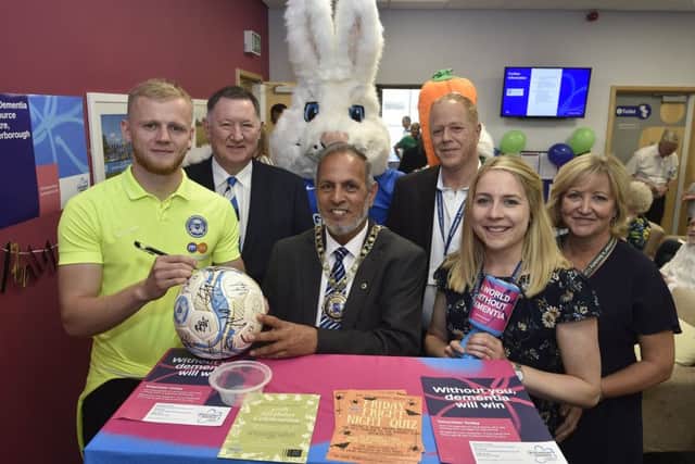Bob Symns and Frazer Blake-Tracy from Peterborough United with Mayor of Peterborough Cllr Gul Nawaz and Kevin Bowyer, Jess Chester and Debbie Holmes at the Dementia Resource Centre's 5th birthday event. EMN-190913-173905009