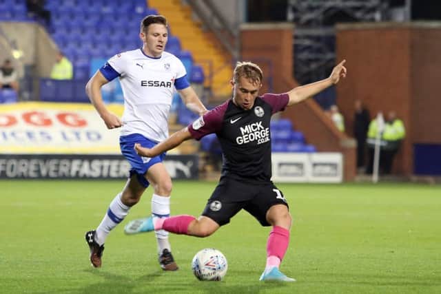 Louis Reed of Peterborough United in action with Paul Mullin of Tranmere Rovers. Photo: Joe Dent/theposh.com