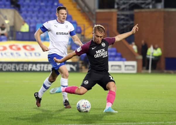 Louis Reed of Peterborough United in action with Paul Mullin of Tranmere Rovers. Photo: Joe Dent/theposh.com