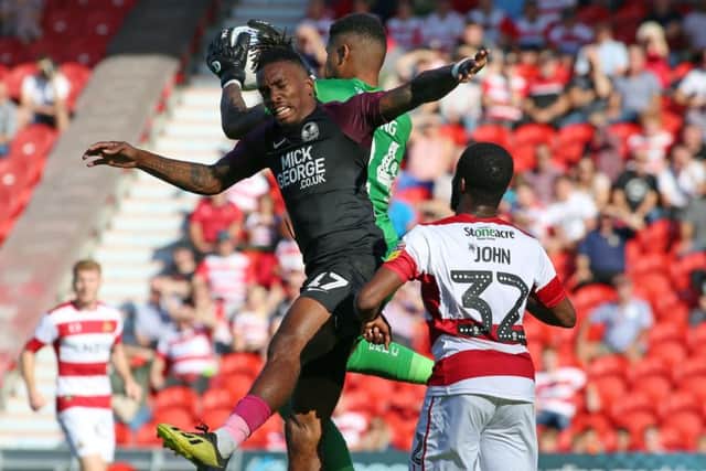 Ivan Toney of Peterborough United challenges for the ball at Doncaster. Photo: Joe Dent/theposh.com.
