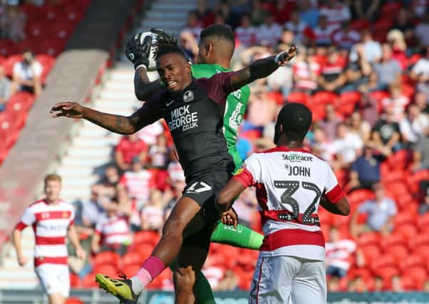 Ivan Toney of Peterborough United challenges for the ball at Doncaster. Photo: Joe Dent/theposh.com.