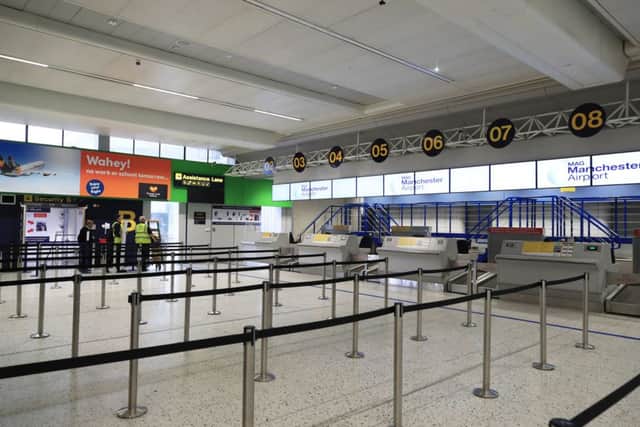 Empty check-in desks at Manchester Airport. Photo: Peter Byrne/PA Wire