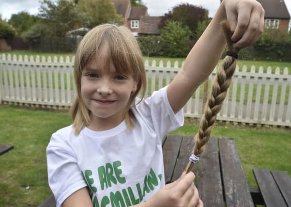 Lillie-Evelyn Smith (6) have a haircut in aid of Little Princess Trust at the Dragon pub, Werrington. EMN-190928-182015009