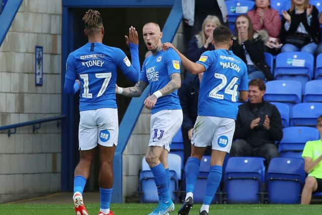 Marcus Maddison of Peterborough United (middle) celebrates his goal against Wimbledon. Photo: Joe Dent/theposh.com.