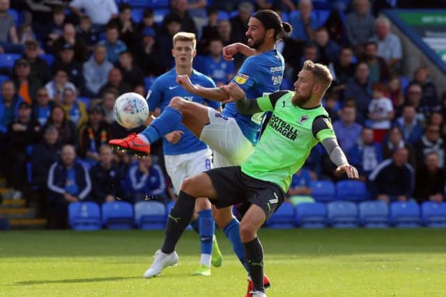 George Boyd of Peterborough United in action with Scott Wagstaff of AFC Wimbledon. Photo: Joe Dent/theposh.com.