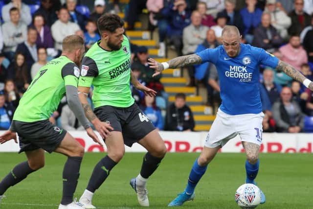 Marcus Maddison of Peterborough United takes on Anthony Wordsworth and Scott Wagstaff of AFC Wimbledon. Photo: Joe Dent/theposh.com.