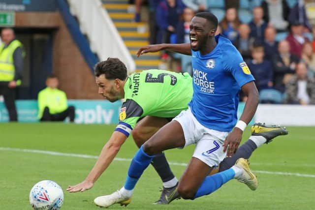 Posh striker Mo Eisa wanted a penalty following this challenge by Wimbledon defender Will Nightingale. He didn't get it. Photo: Joe Dent/theposh.com.