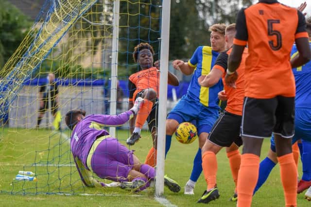 Peterborough Sports striker Mark Jones is about to bundle the ball over the line against Leiston. Photo: James Richardson.