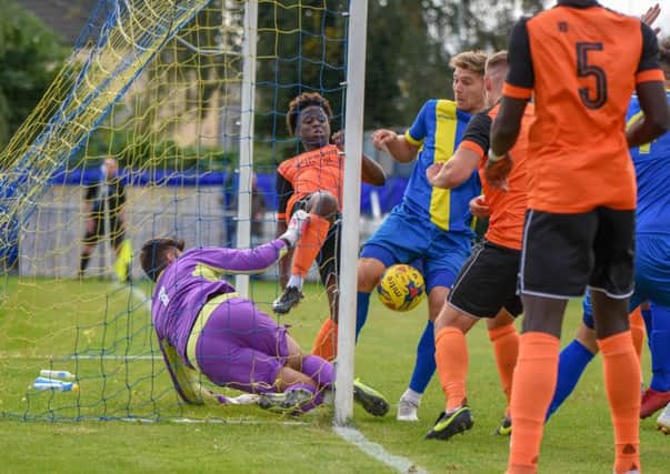 Peterborough Sports striker Mark Jones is about to bundle the ball over the line against Leiston. Photo: James Richardson.