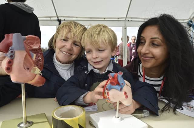 Anne Scofield and son Patrick (5) with Raj Darar looking at heart models. EMN-190928-181729009