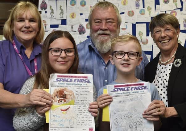 Werrington library assistant Sue Rushen with Coun John  and Judy Fox and  summer reading challenge winners Kayla Allen (10) and Oliver Allen (9).