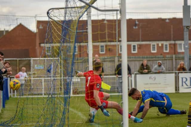 This effort from Peterborough Sports centre-back Paul Malone was kept out by the Guiseley goalkeeper. Photo: James Richardson.
