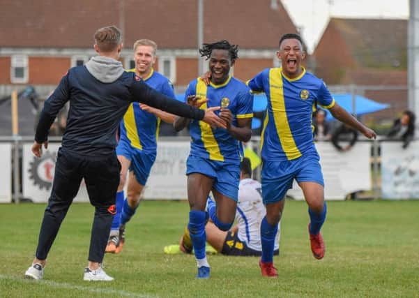 Peterborough Sports pair Maniche Sani (centre) and Dion Sembie-Ferris (right) celebrate the former's goal against Guiseley. Photo: James Richardson.