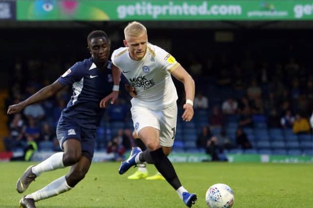 Posh left-back Frazer Blake-Tracy (white).