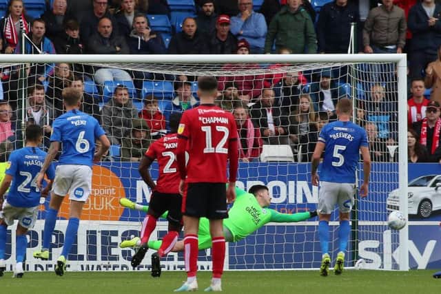 Christy Pym of Peterborough United makes a diving save to deny Lincoln City. Photo: Joe Dent/theposh.com.