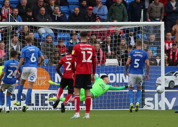Christy Pym of Peterborough United makes a diving save to deny Lincoln City. Photo: Joe Dent/theposh.com.