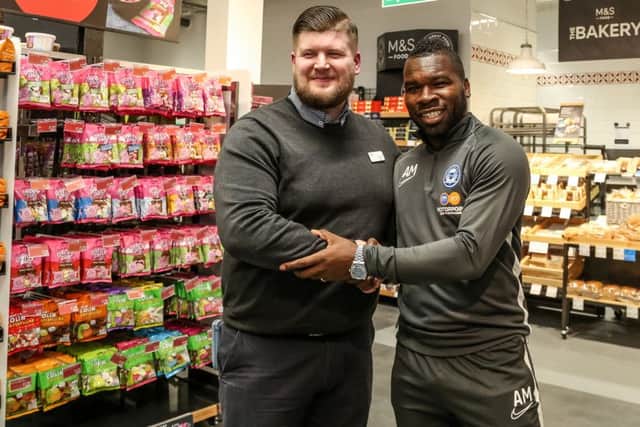 Aaron Mclean (right) with M&S Serpentine Green Peterborough store manager Adam Thomson. Photo: Joe Dent