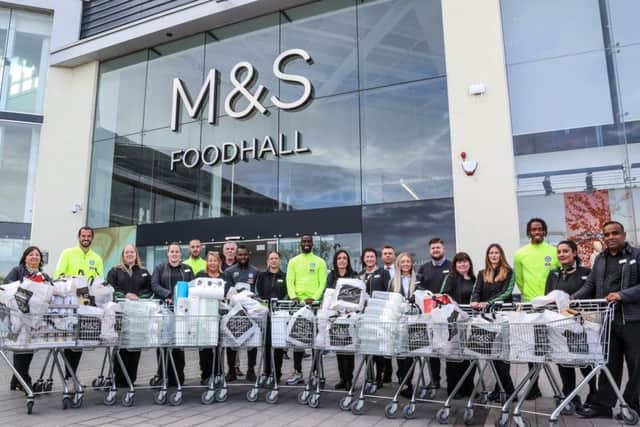 Posh players and staff with M&S staff at the Serpentine Green store. Photo: Joe Dent