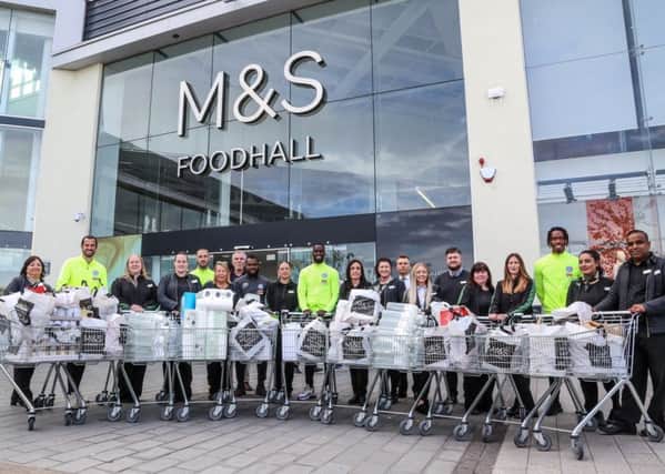Posh players and staff with M&S staff at the Serpentine Green store. Photo: Joe Dent