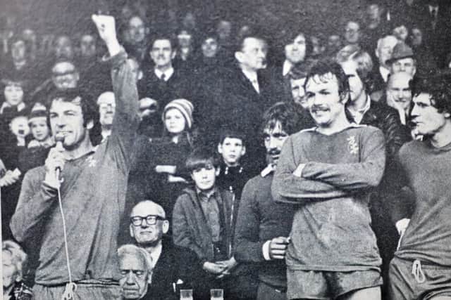Tommy (left, with mic) wearing the shirt after Posh had won the title
