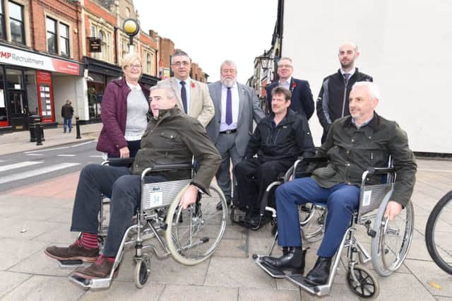 Senior figures in Peterborough trying different routes into the city centre on wheelchairs in 2017