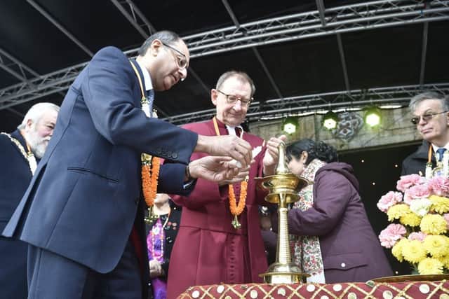 Diwali celebrations in the City Centre. 2018  Shailesh Vara MP and   The Very Revd. Christopher Dalliston, Dean of Peterborough Cathedral   lighting candles EMN-181027-170000009