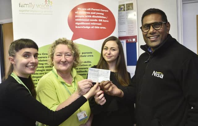 Sam D'Santos and Christine Nicholls receiving a cheque for a Family Voice Halloween party from  Callie Hargreaves and Thievenayagam Sivarajah from Nisa stores EMN-191014-172617009
