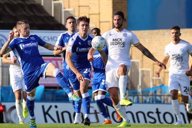 George Boyd of Peterborough United in action with Mark Byrne of Gillingham. Photo: Joe Dent/theposh.com.