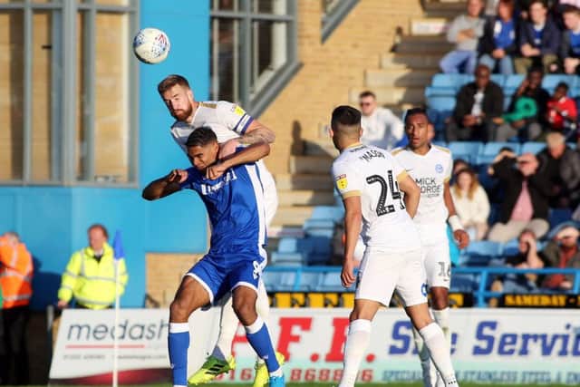 Posh centre-back Mark Beevers duels with Mikael Mandron of Gillingham. Photo: Joe Dent/theposh.com.