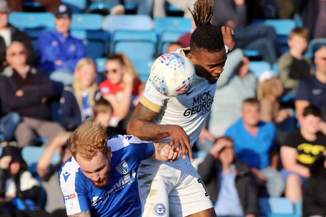 Posh striker Ivan Toney competes with Connor Ogilvie of Gillingham. Photo: Joe Dent/theposh.com.