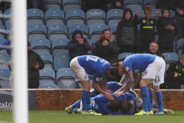 Posh striker Mo Eisa is mobbed by teammates after equalising in the 95th minute against Coventry. Photo: Joe Dent/theposh.com.