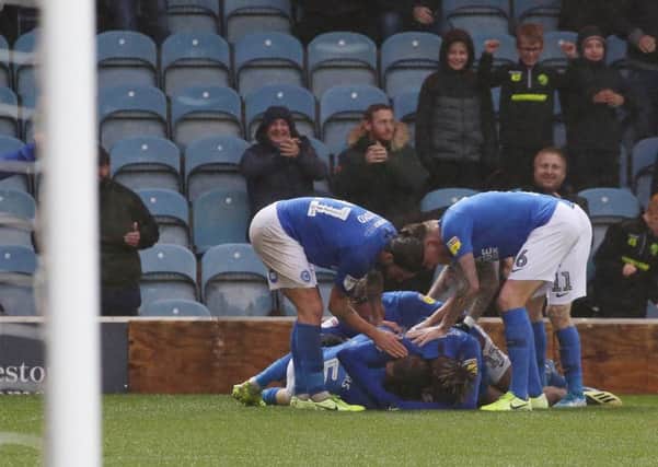 Posh striker Mo Eisa is mobbed by teammates after equalising in the 95th minute against Coventry. Photo: Joe Dent/theposh.com.