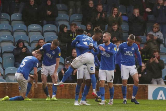 Mohamed Eisa of Peterborough United is mobbed by team-mates after scoring a late equalising goal against Coventry. Photo: Joe Dent/theposh.com.