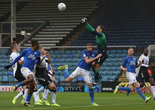 Coventry City goalkeeper Marko Marosi punches clear under pressure from Mark Beevers. Photo: Joe Dent/theposh.com.