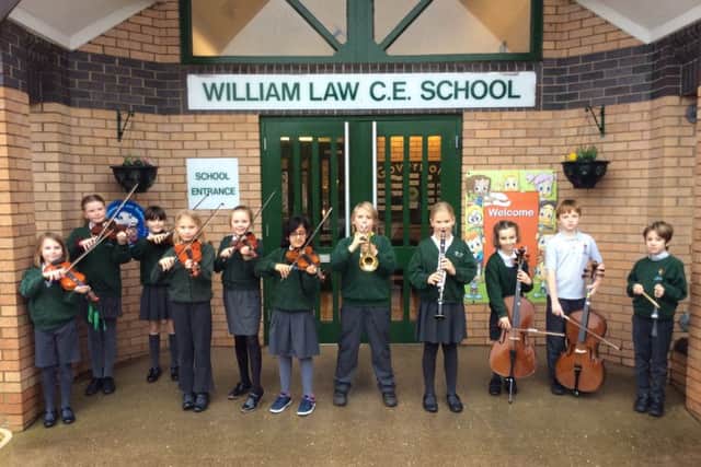 William Law orchestra playing outside the school at the end of the day.
