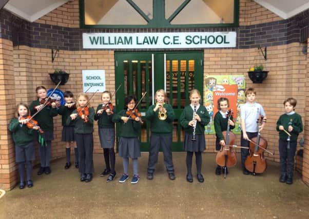 William Law orchestra playing outside the school at the end of the day.