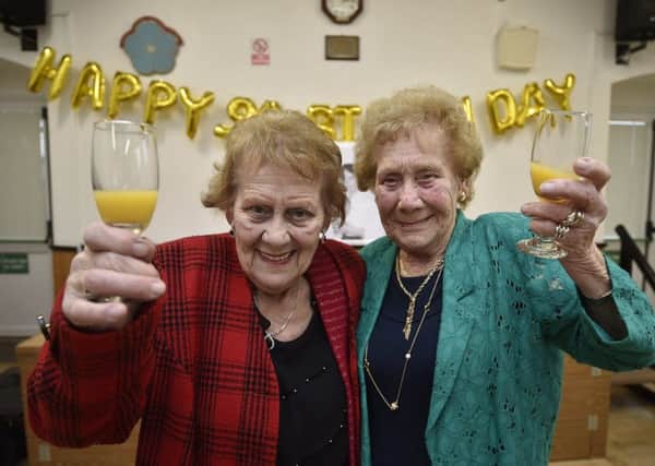 Twins Peggy Green (wearing red) and Kathleen Schneider (wearing green) celebrating their 90th birthdays at Coates village hall EMN-191027-095243009